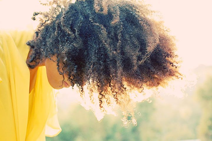 Ndoema The Global Girl enjoys the delicate fragrance of mimosa and a gorgeous ray of sunshine during magic hour in the countryside.