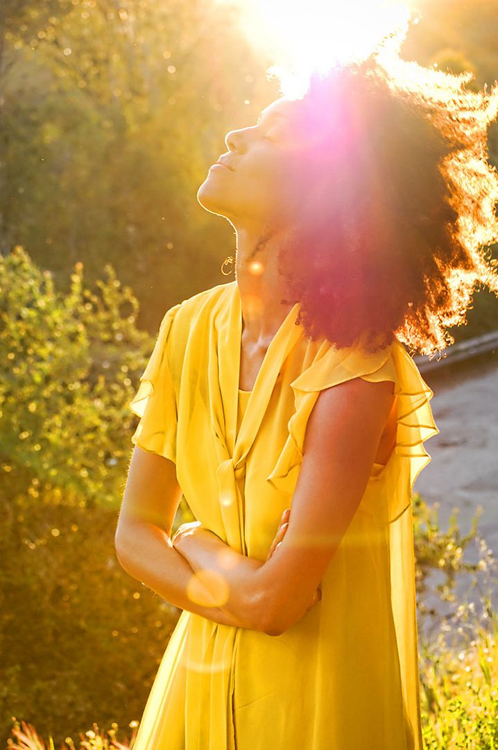 Ndoema The Global Girl enjoys the delicate fragrance of mimosa and a gorgeous ray of sunshine during magic hour in the countryside.