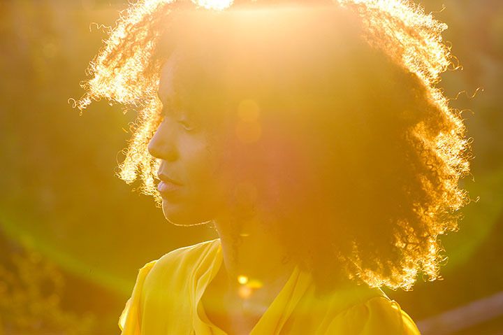 Ndoema The Global Girl enjoys the delicate fragrance of mimosa and a gorgeous ray of sunshine during magic hour in the countryside.
