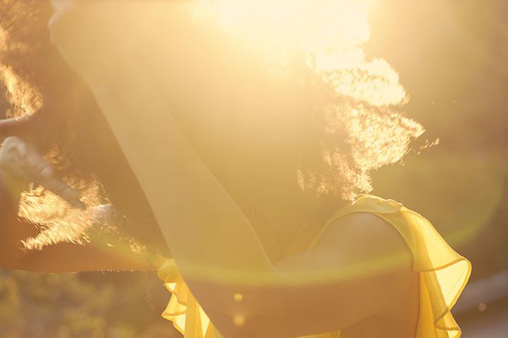 Ndoema The Global Girl enjoys the delicate fragrance of mimosa and a gorgeous ray of sunshine during magic hour in the countryside.