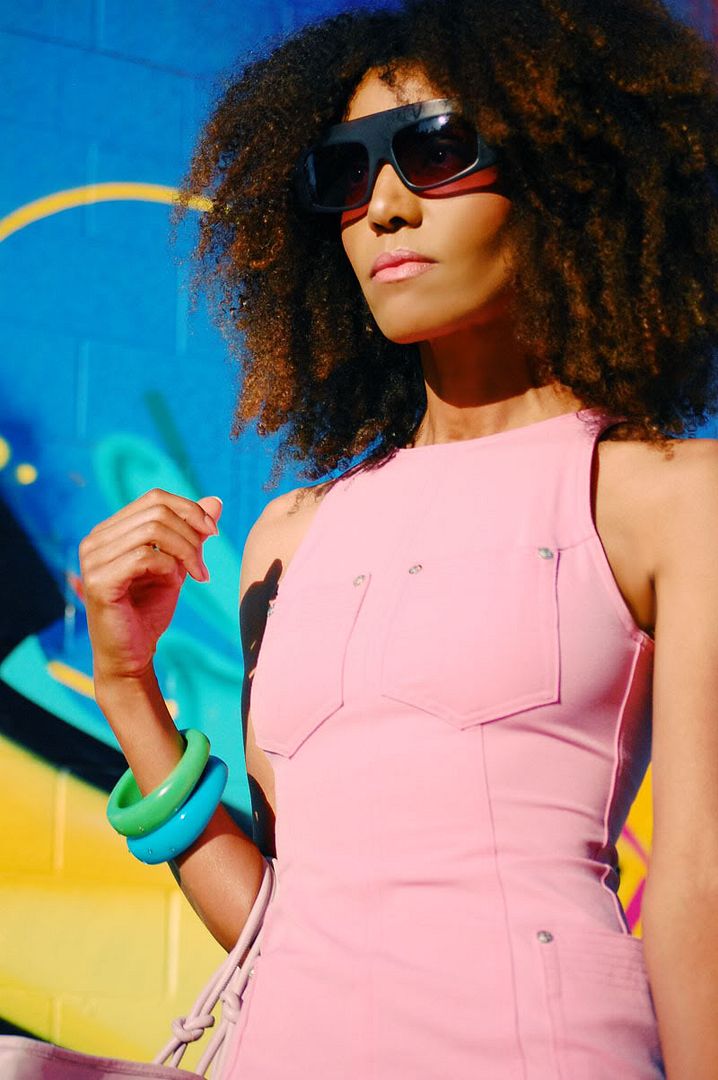 Ndoema The Global Girl sports a pink Versace dress, Phillip Lim sunglasses, Paola Graglia Bag and Report Signature floral high heel shoes